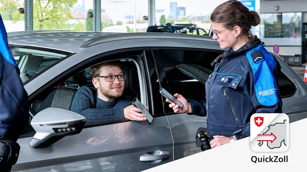 A customs employee checks a driver's documents using an app. Both are holding smartphones.
